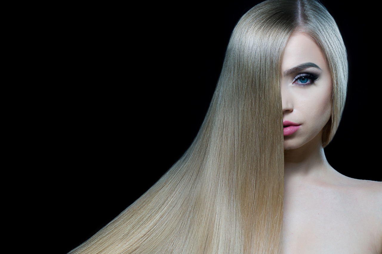 Beautiful model girl with smooth blond hair. Perfect hair